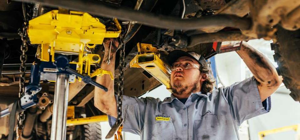 heavy equipment & diesel student student working underneath a lifted diesel truck